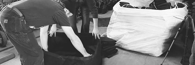 Kevin Jodrey inspecting black fabric pot.